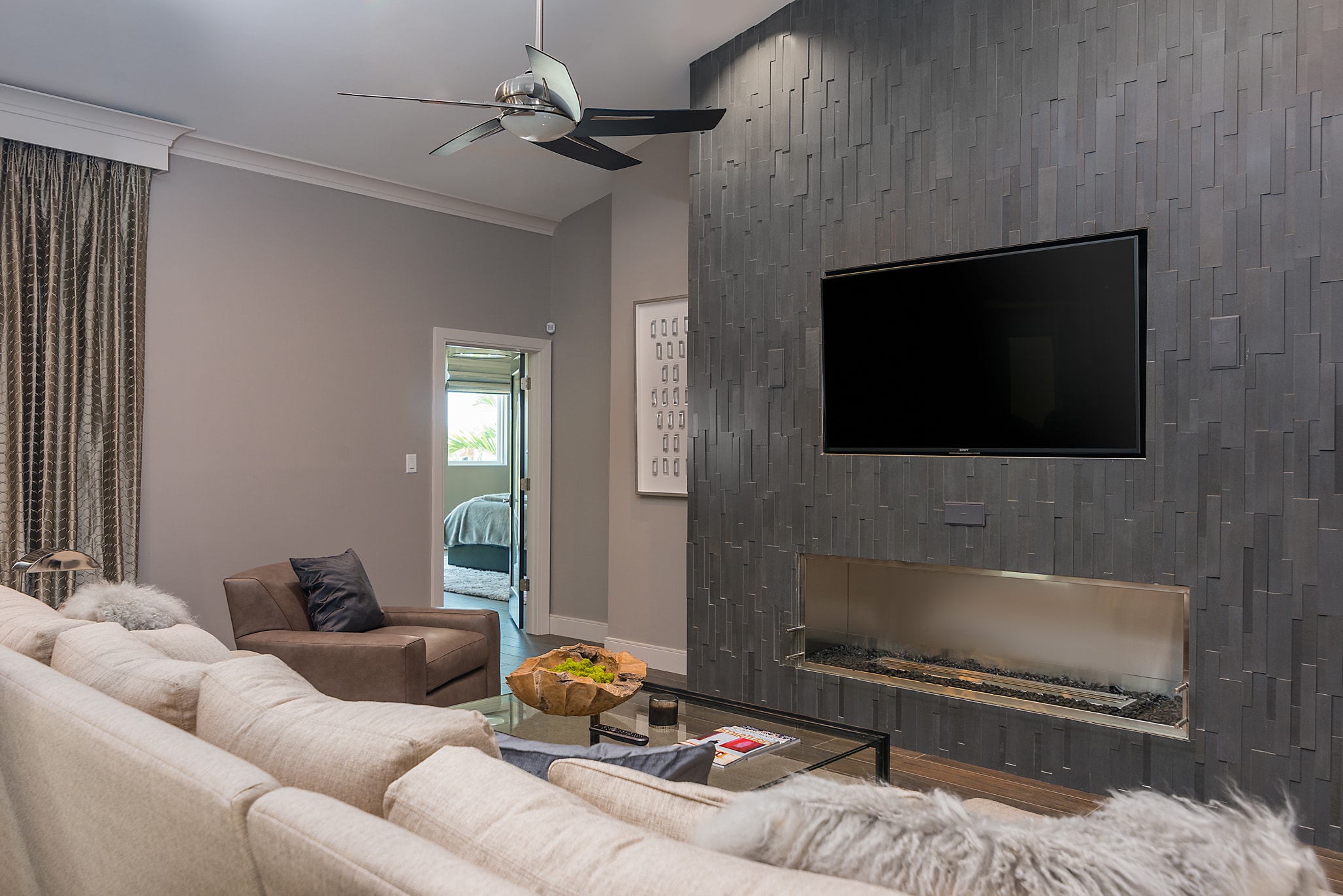 Norstone Basalt Grey Aksent 3D Modern Stone Veneer Panels used on a modern styled fireplace with a linear gas fireplace insert and built in flat screen tv